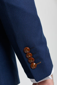 Costume trois pièces bleu marine pour homme, finitions marron, motif œil-de-perdrix classique, style vintage, idéal pour les mariés.