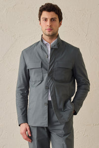 Costume deux pièces pour homme, vert sauge, style safari, col montant, coupe élégante et décontractée.