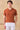 Polo homme en maille côtelée orange rouille