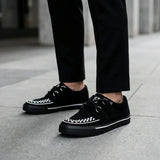 Baskets Creeper pointues à plateforme en daim noir et blanc